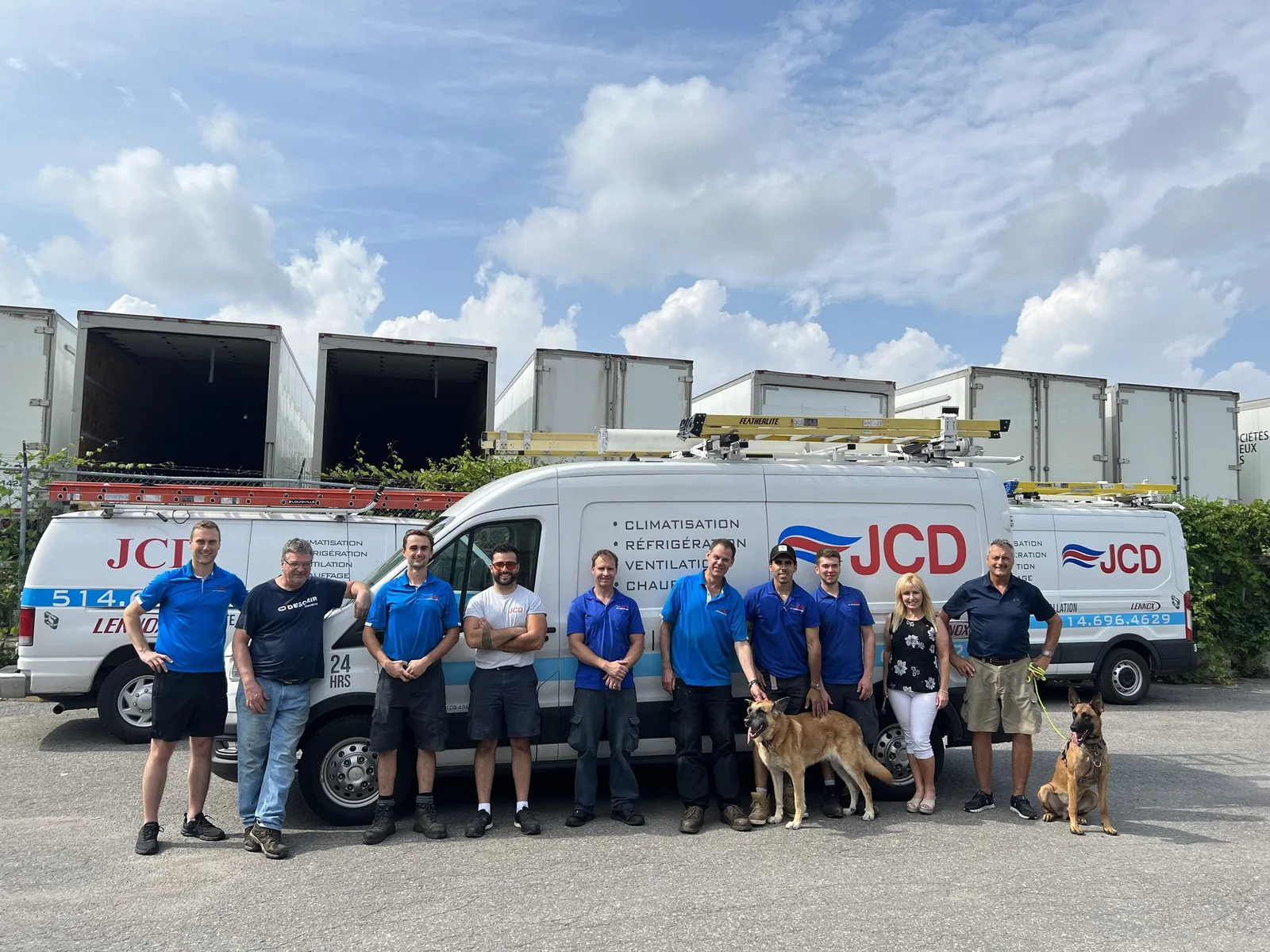 The JCD team in front of the service vans