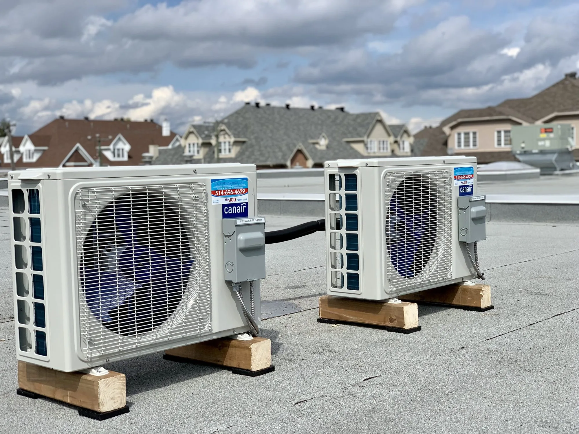 Two Canair ductless outdoor units installed on a flat roof